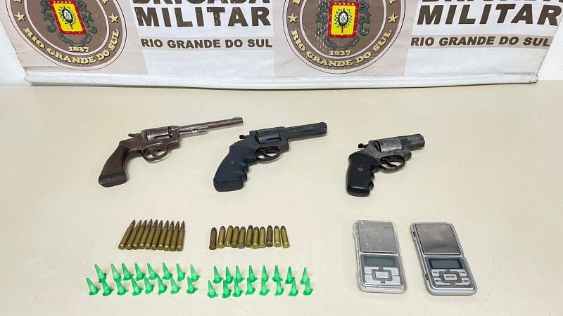 Na imagem, três revólveres calibre .38, munições, pinos de cocaína e duas balanças de precisão