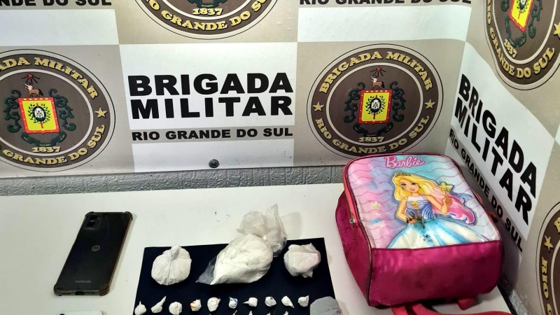 Na foto contém droga, telefone e uma mochila.