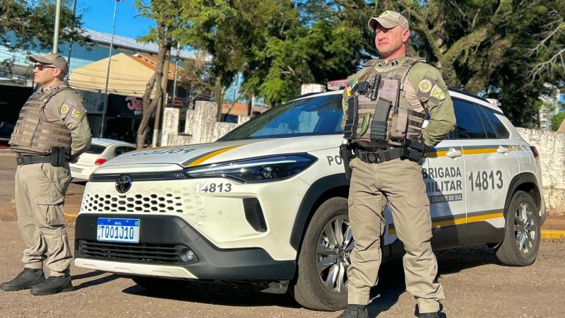 Na foto dois policiais militares com a viatura